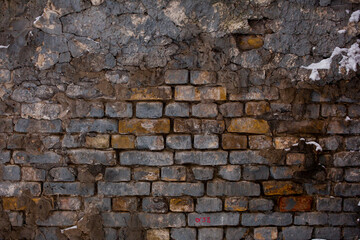 Brick wall with the whitewash falling off fragment as a background texture. Vintage or grungy white...