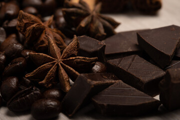 Star anise, coffee beans and dark chocolate up close 