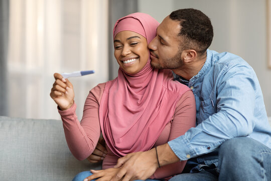 Becoming Parents. Portrait Of Black Muslim Spouses With Positive Pregnancy Test