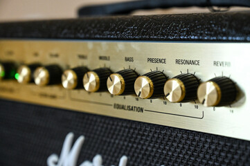 Music amplifier for guitar. Amplifier controls on speaker.