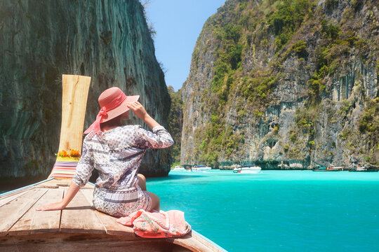 Woman travelling by boat in summer vacation among islands Phi Phi in Thailand.