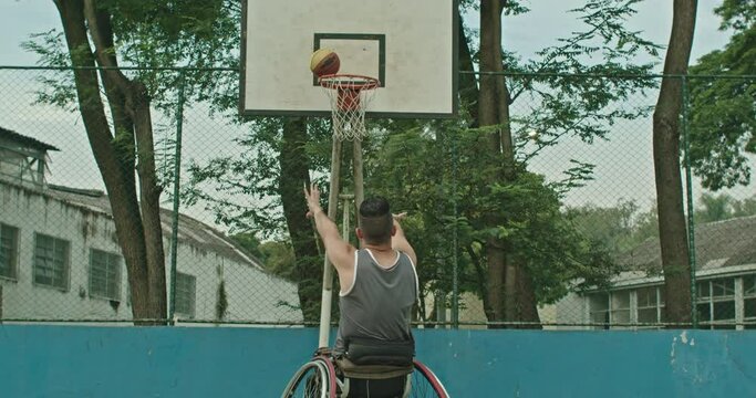 One paraplegic basketball player missing ball hoop outside. Determination disability concept