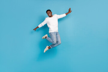 Fototapeta na wymiar Full size photo of overjoyed person enjoy freedom jumping isolated on blue color background
