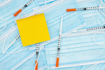 Disposable surgical face mask and needles with note - obrazy, fototapety, plakaty