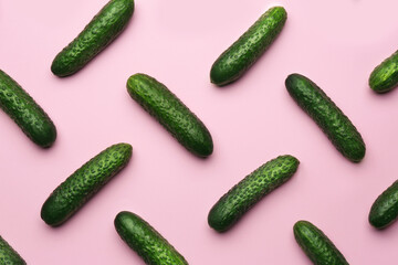Flat lay composition with fresh ripe cucumbers on pink background