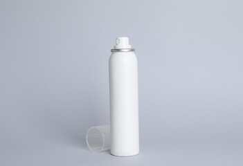 Bottle of dry shampoo on grey background