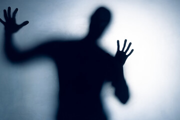 Composition of black silhouette of man with shadows on white background
