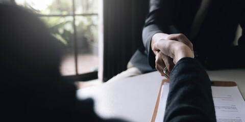 Lawyer business women shaking hands with clients, after finishing up a Consulting for insurance rent house. concept of home protection, family, insurance.