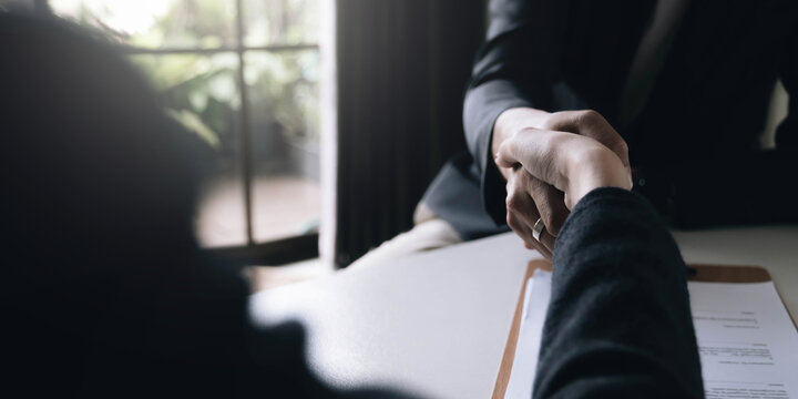 Lawyer business women shaking hands with clients, after finishing up a Consulting for insurance rent house. concept of home protection, family, insurance.