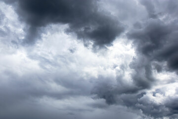 Dark and dramatic storm clouds. Sun light behind storm clouds.
