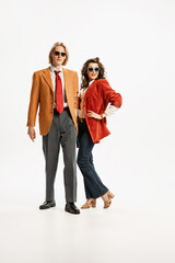 Portrait of young people, man and woman in stylish outfit posing isolated over white studio background. Vintage fashion