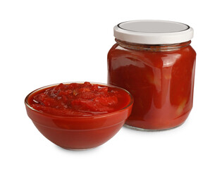 Glass jar and bowl of delicious lecho on white background