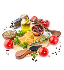 Fresh tomatoes with basil leaves, rosemary,  pepper, olive oil and cheese  isolated on white background. Ripe tomatoes with spices.