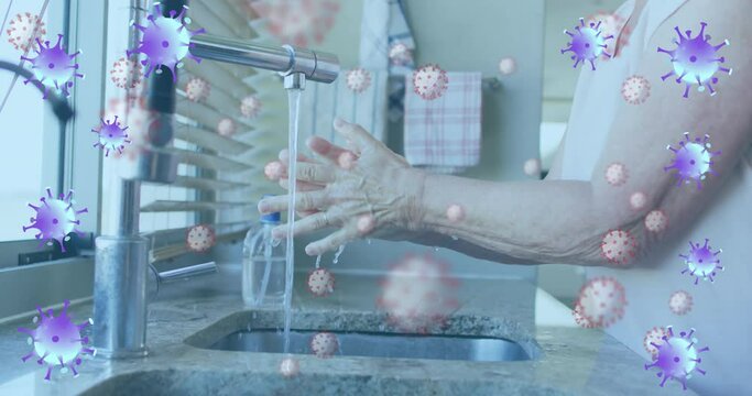 Animation of purple virus cells over hands pf caucasian senior man washing hands