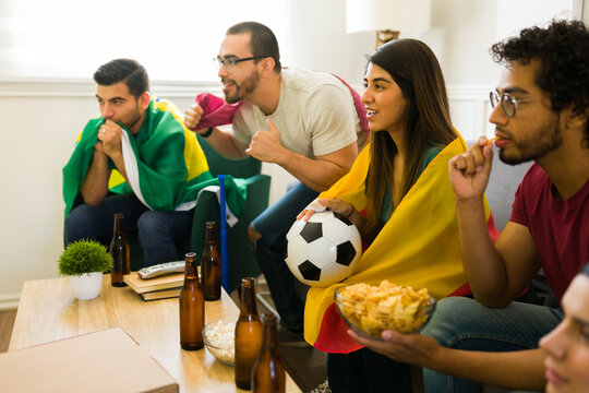 Anxious women and men watching the soccer world cup together