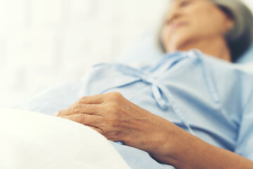 Old hands woman laying on bed at hospital ward. medicine, health care, old people and quarantine...