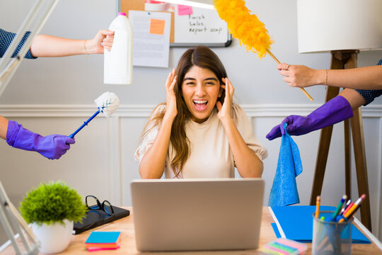 Overwhelmed Woman Working Remotely And Doing Housework