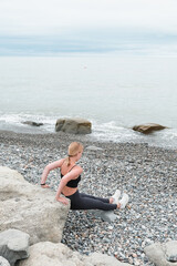 sport fit outdoor sea.girl goes sports,fitness,yoga seashore.Meditation, relaxation, mental health.Active lifestyle, self-care, health.Wellness.Fit nature.myofascial release workouts tracking fitness