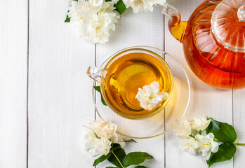 Jasmine tea in a cup on a wooden background. Copy space
