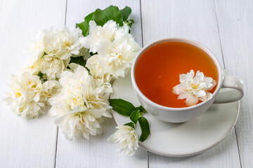 Jasmine tea in a cup on a wooden background.