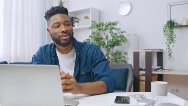 Happy African American man counting money, planning on buying something