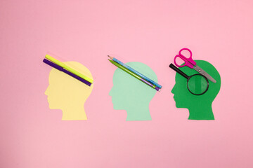 three male paper heads with different school supplies, it's time to think about what we need for school