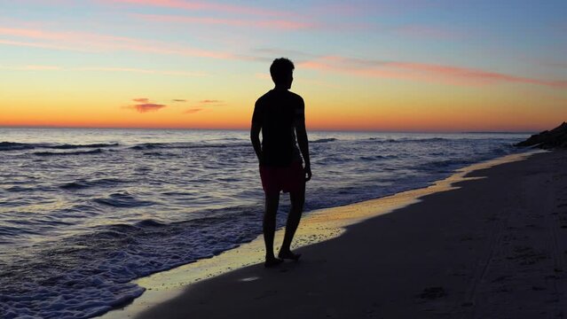 Teen being macho masculine silhouette on coast 