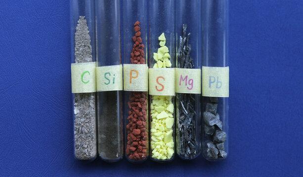 Simple natural substances of inorganic origin in test tubes: gray carbon, amorphous black silicon, crystals of red phosphorus, yellow sulfur, shavings of light magnesium, pieces of heavy lead.