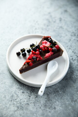 Homemade raw chocolate cake with berries