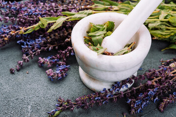 Salvia,  sage purple fresh flowers on marble mortar. .herbal  for medicine and cosmetology. ...