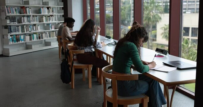 Young group of students studying inside university library - Back to school and college lifestyle concept 
