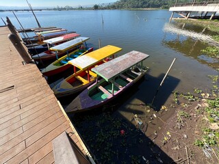 Beautiful Calm Water Reflection Lake and Fisherman working fishing on Boats with Blue Sky and Sunny Weather Clear Horizon