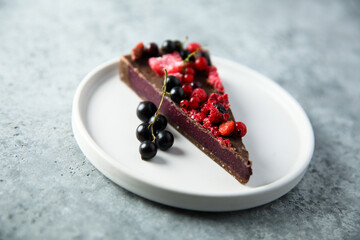 Homemade raw chocolate cake with berries