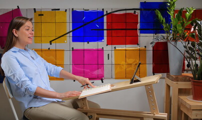 Woman designer doing online learning or teaching and working with color palette.