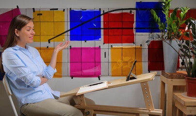Woman designer doing online learning or teaching and working with color palette.