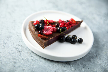 Homemade raw chocolate cake with berries