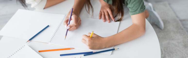 high angle view of babysitter and kid drawing on paper, banner.