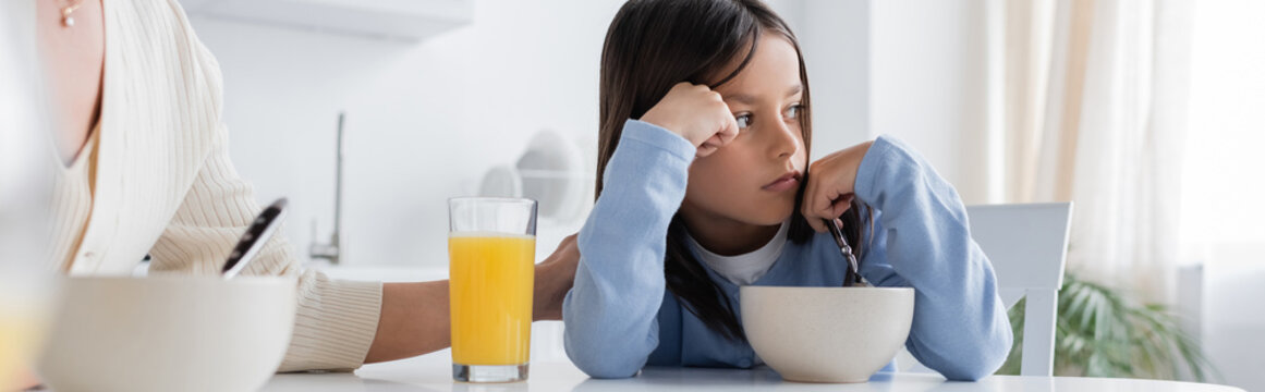 Frustrated Child Sitting Near Nanny And Looking Away During Breakfast, Banner.