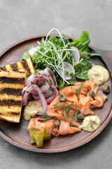 salmon gravlax platter with salad and toast in sweden