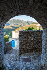 View over a classic traditional Mediterranean village through the house arch and a rock pavement Mediterranean style. Picture taken in Albanian city of Himara the old part. Albania