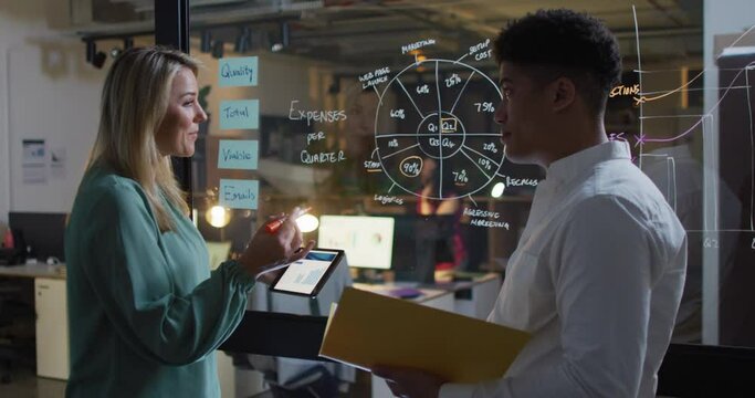 Video of diverse female and male coworkers brainstorming, working late in office
