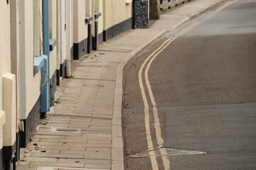 Double yellow lines on a side street in Sidmouth, Devon. The roads are very narrow and no parking is allowed