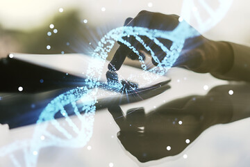 Creative concept with DNA symbol illustration and finger clicks on a digital tablet on background. Genome research concept. Multiexposure