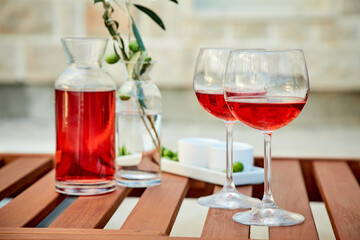 Glasses of red wine against sunset