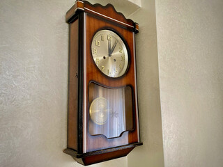 vintage old wooden clock on the wall. Retro vintage style brown clock. Antique watch.