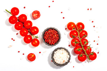 Cooking background with tomato cherry, sea salt, and rose peppercorn isolated on white background