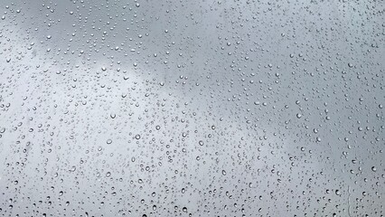 mage of rain drops falling on glass for background