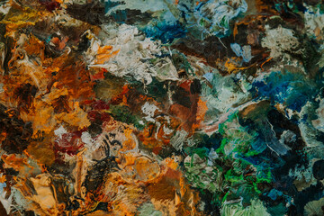 Artists multicolored oil paints on wooden palette or canvas.Orange and green. Close-up abstract background. Art concept