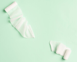 First aid, injury protecting wrapping and wound dressing concept clean cotton gauze bandage isolated on colorful background with space for sign.