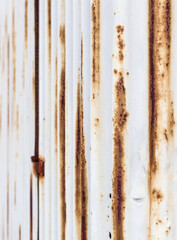 Rusted white corrugated iron plate.
